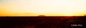 Uluru Ayers Rock on Horizon at Sunset