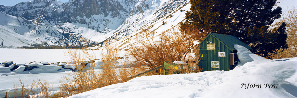 Snow covered lake & boathouse