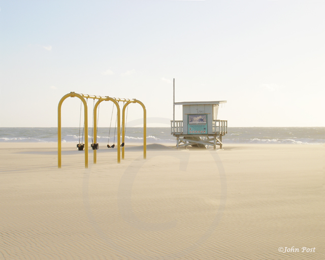 view to swings and lifeguard toweron a windy day at the beach.