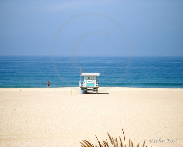 Man standin on beach looking at ocean