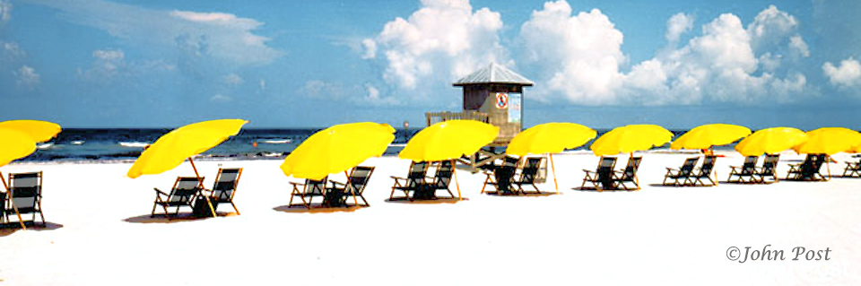 row of beach chairs and brollys & tower