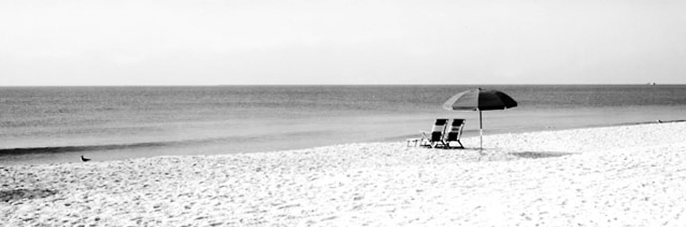 two beach chairs and brolly