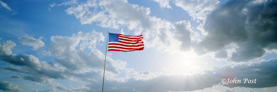Giant American flag blowing in wind at the last truck stop in Arizona
