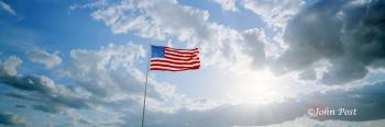 American Flag Wind and Sun Thru Clouds